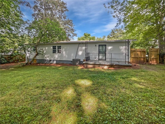 2122 Belhaven Ln SE, Atlanta, GA 30315 - rear view of property featuring a lawn, fence, and central air condition unit
