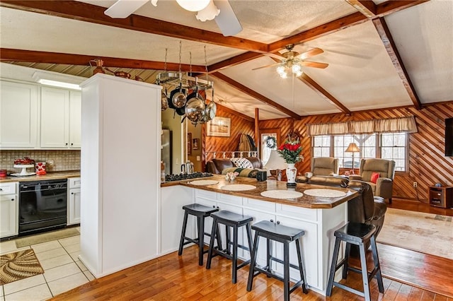 kitchen featuring vaulted ceiling with beams, ceiling fan, and a breakfast bar