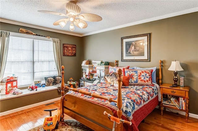 bedroom with ceiling fan, ornamental molding, dark wood-type flooring, and a textured ceiling