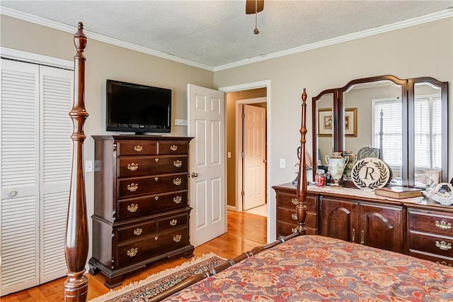 bedroom featuring a closet, ornamental molding, ceiling fan, and a textured ceiling