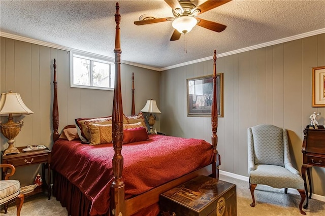 carpeted bedroom featuring ceiling fan, ornamental molding, and a textured ceiling