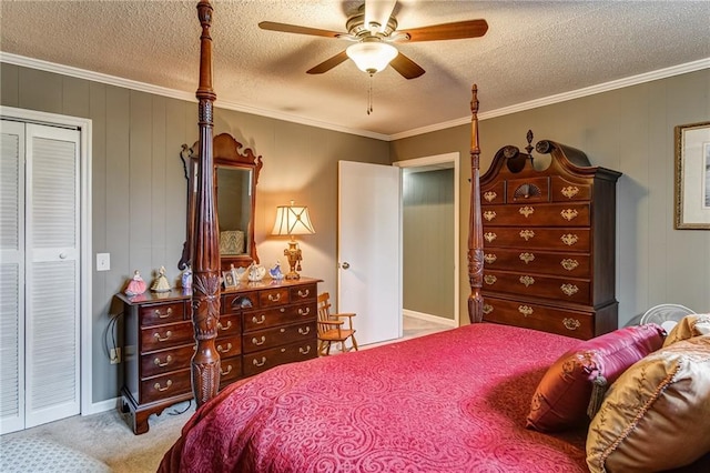 carpeted bedroom with a closet, ceiling fan, a textured ceiling, and crown molding