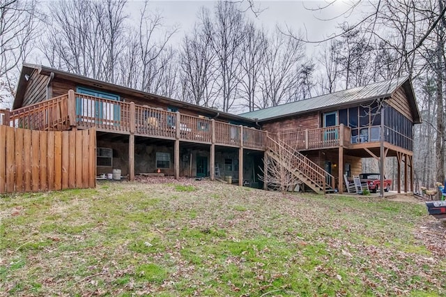 back of house featuring a deck and a yard