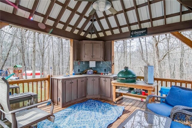 exterior space with a gazebo and ceiling fan