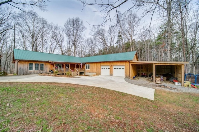 view of front of property featuring a garage and a carport