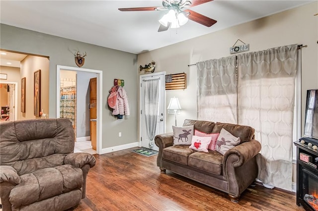 living room featuring ceiling fan and hardwood / wood-style flooring