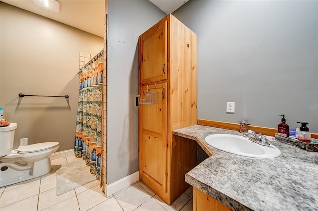 bathroom featuring tile floors, toilet, and vanity