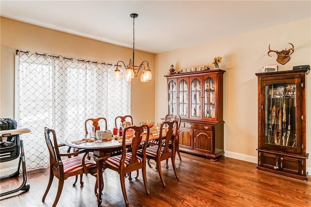 dining room featuring an inviting chandelier and dark hardwood / wood-style flooring