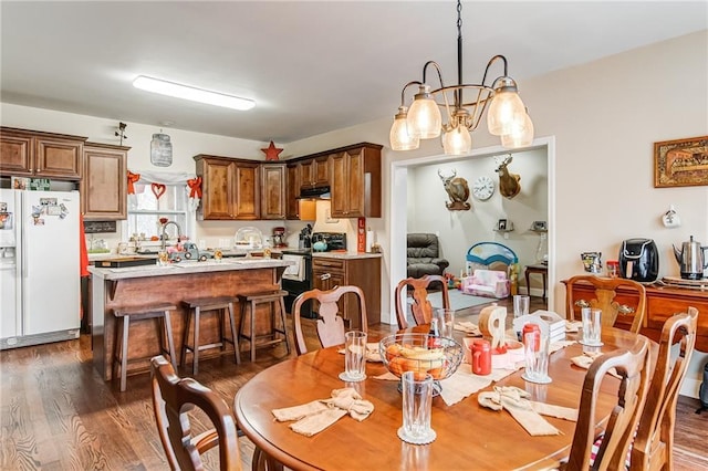 dining room with a notable chandelier and dark hardwood / wood-style flooring