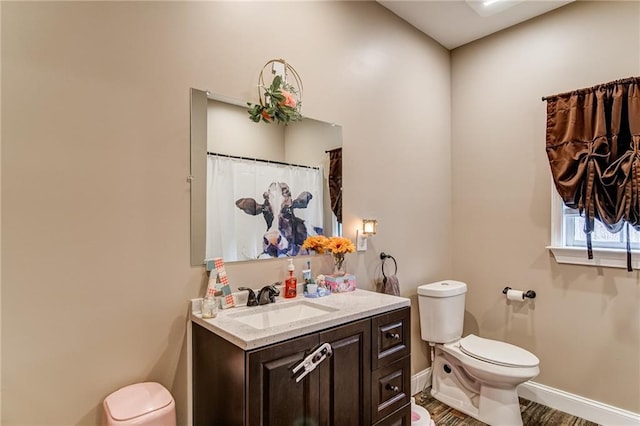 bathroom with vanity, hardwood / wood-style floors, and toilet