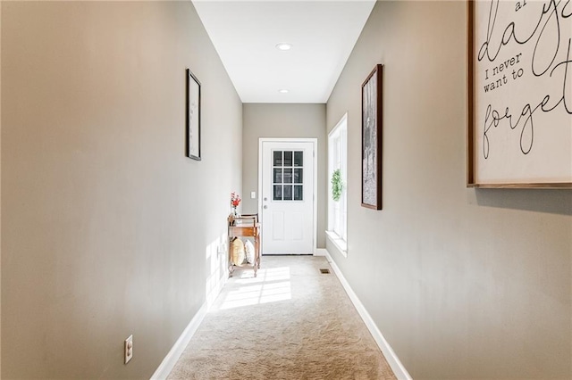 hallway with light colored carpet