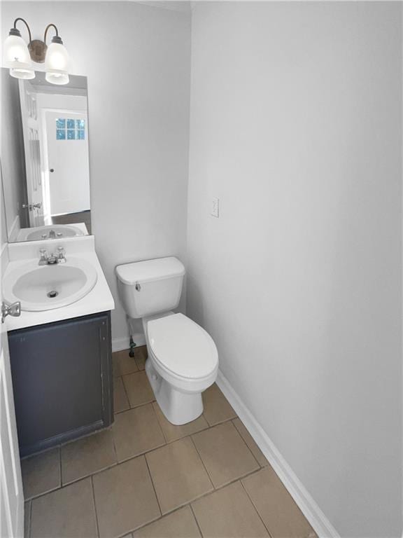 bathroom featuring toilet, vanity, and tile patterned flooring