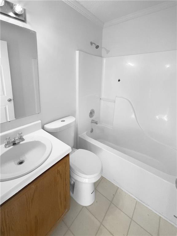 full bathroom featuring toilet, vanity, tile patterned flooring, shower / bath combination, and ornamental molding