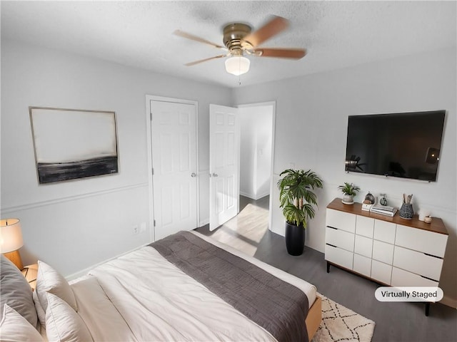 bedroom with ceiling fan and dark hardwood / wood-style flooring