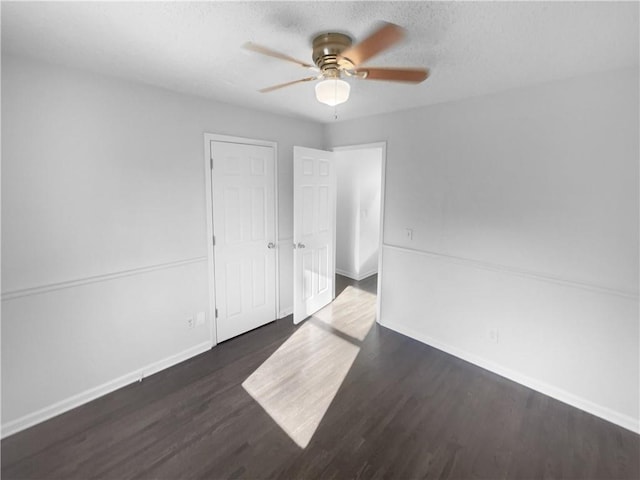 unfurnished room with ceiling fan and dark hardwood / wood-style floors