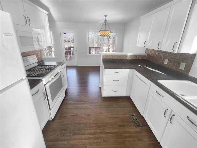 kitchen with white cabinetry, dark hardwood / wood-style flooring, decorative light fixtures, and white appliances