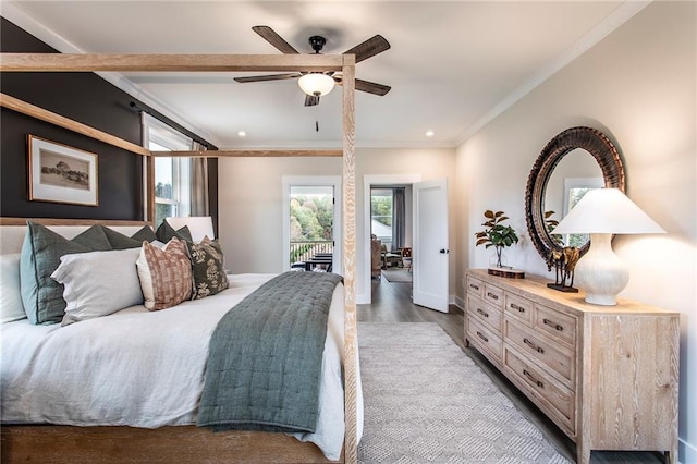 bedroom with crown molding, hardwood / wood-style floors, ceiling fan, and access to outside