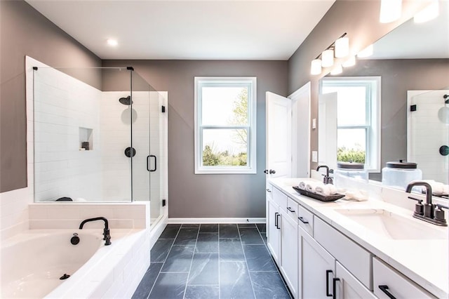 bathroom featuring plenty of natural light, vanity, and separate shower and tub