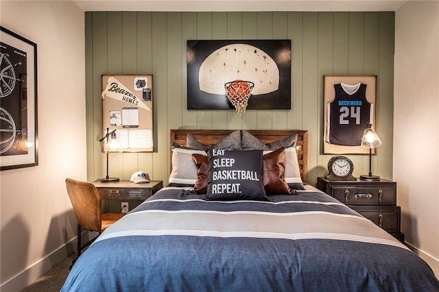 carpeted bedroom with wood walls