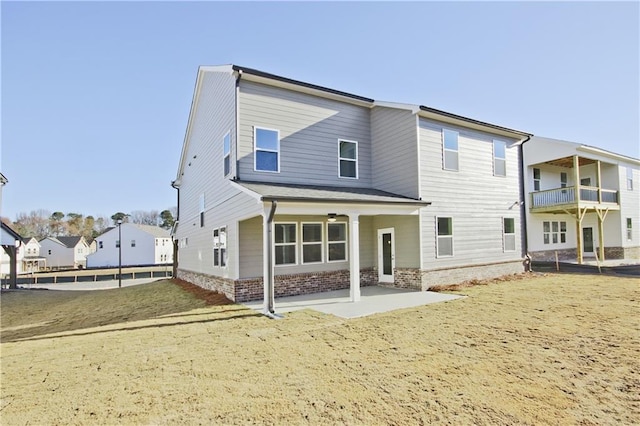 rear view of property with a patio area and a lawn