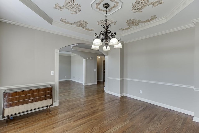 unfurnished dining area with heating unit, hardwood / wood-style flooring, ornamental molding, and a raised ceiling