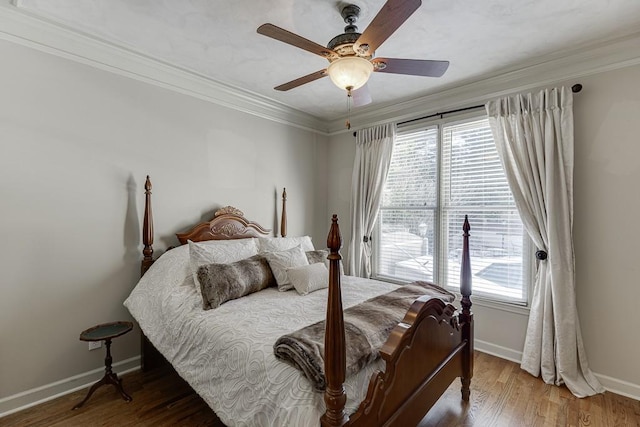 bedroom featuring crown molding, ceiling fan, and hardwood / wood-style flooring