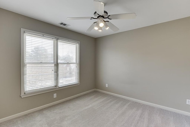 spare room featuring ceiling fan and light colored carpet