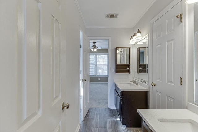 bathroom with vanity and crown molding