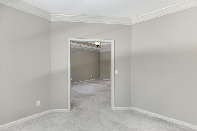 unfurnished room with crown molding and light colored carpet