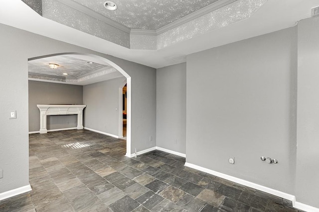 empty room with crown molding and a tray ceiling