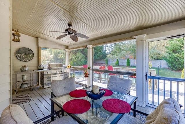 sunroom / solarium with ceiling fan and wooden ceiling