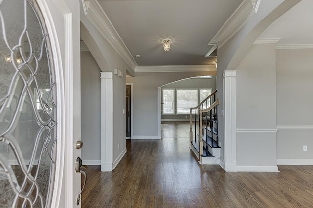 foyer with ornamental molding, dark hardwood / wood-style floors, and ornate columns