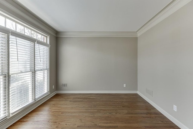 spare room with crown molding and dark hardwood / wood-style flooring