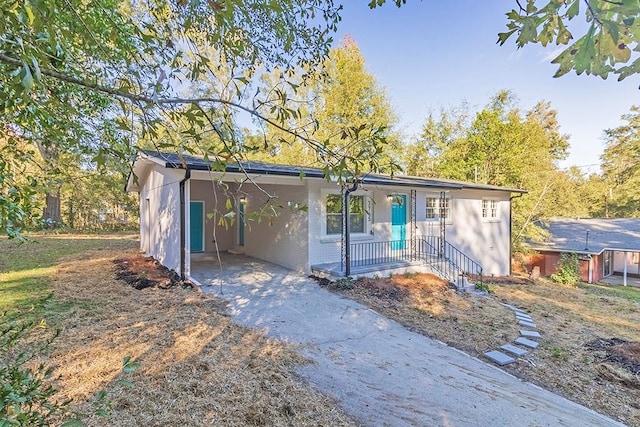 view of front of property with a porch and a carport