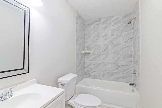 full bathroom featuring vanity, toilet, a textured ceiling, and tiled shower / bath combo