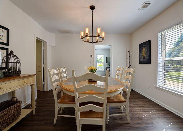 dining room with baseboards, visible vents, a chandelier, and dark wood-style flooring