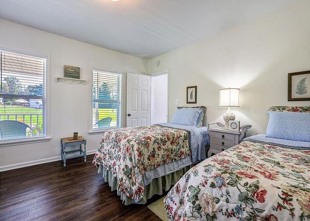 bedroom featuring baseboards and dark wood finished floors