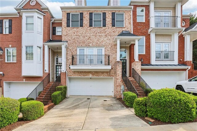 1215 Comet View Trl SE, Smyrna, GA 30082 - townhome / multi-family property with brick siding, a garage, and driveway