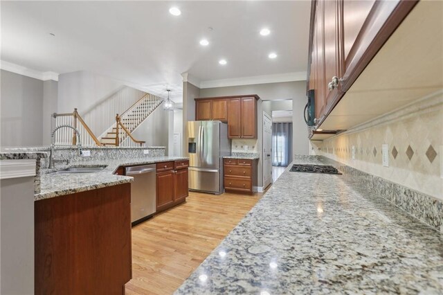 1215 Comet View Trl SE, Smyrna, GA 30082 - kitchen featuring crown molding, a sink, stainless steel appliances, light wood-type flooring, and tasteful backsplash