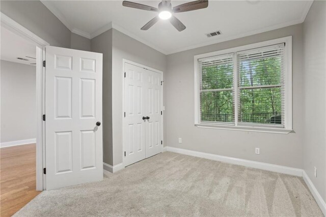 1215 Comet View Trl SE, Smyrna, GA 30082 - unfurnished bedroom with crown molding, baseboards, carpet floors, and visible vents