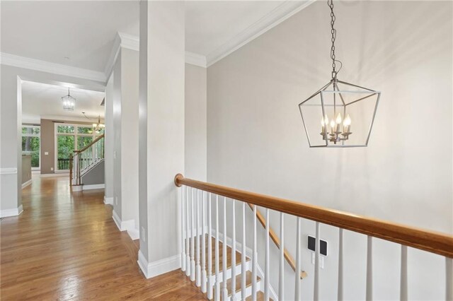 1215 Comet View Trl SE, Smyrna, GA 30082 - hall featuring crown molding, baseboards, wood finished floors, and a notable chandelier
