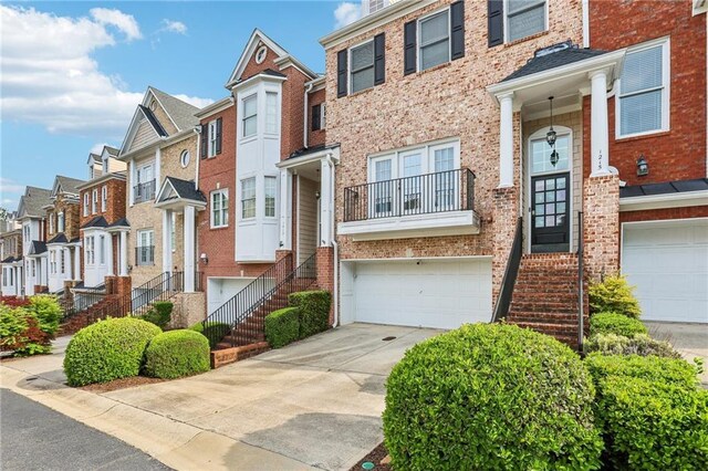 1215 Comet View Trl SE, Smyrna, GA 30082 - multi unit property with a residential view, brick siding, a garage, stairway, and driveway