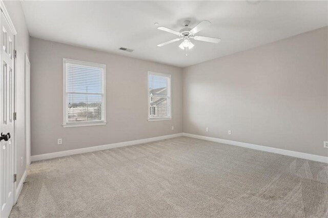 1215 Comet View Trl SE, Smyrna, GA 30082 - unfurnished room with light colored carpet, baseboards, visible vents, and ceiling fan