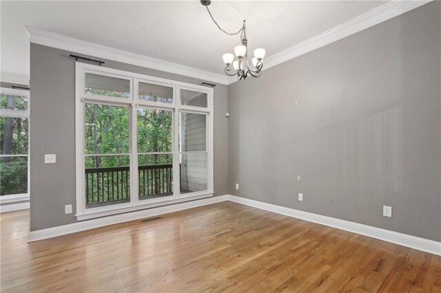 1215 Comet View Trl SE, Smyrna, GA 30082 - unfurnished room with baseboards, ornamental molding, wood finished floors, and a notable chandelier