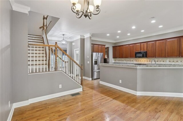 1215 Comet View Trl SE, Smyrna, GA 30082 - kitchen with stainless steel fridge, a chandelier, black microwave, and visible vents