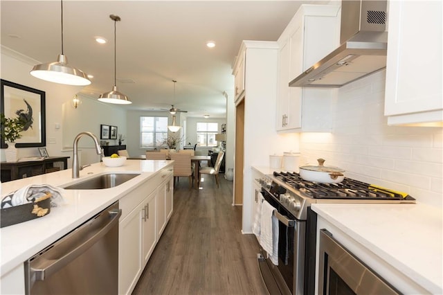 506 Healy Dr Unit 74, Cumming, GA 30040 - kitchen with stainless steel appliances, a sink, wall chimney exhaust hood, white cabinets, and light countertops
