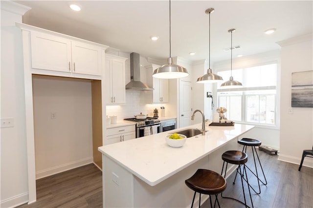 506 Healy Dr Unit 74, Cumming, GA 30040 - kitchen with wall chimney range hood, stainless steel range with gas stovetop, a sink, dark wood finished floors, and recessed lighting