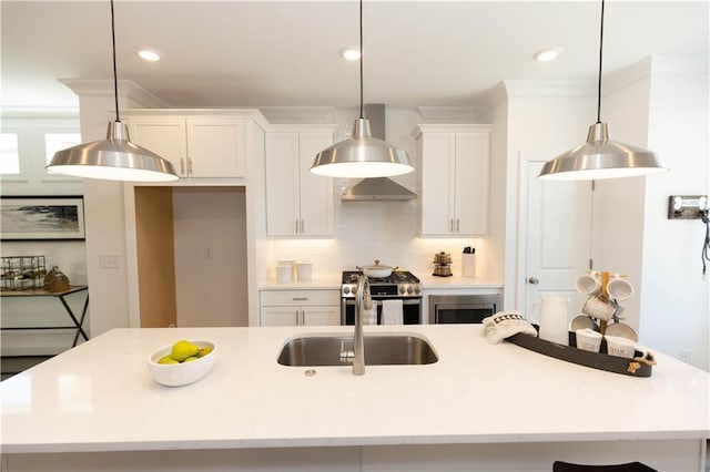 506 Healy Dr Unit 74, Cumming, GA 30040 - kitchen featuring stainless steel appliances, white cabinets, exhaust hood, a center island with sink, and ornamental molding