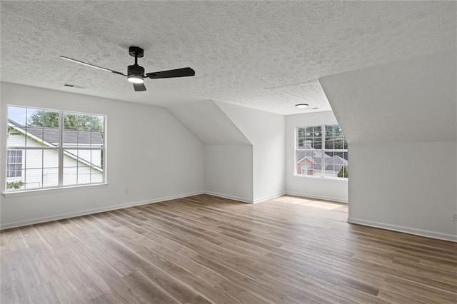 1069 Alford Rd, Lithonia, GA 30058 - additional living space featuring wood finished floors, healthy amount of natural light, a textured ceiling, ceiling fan, and lofted ceiling