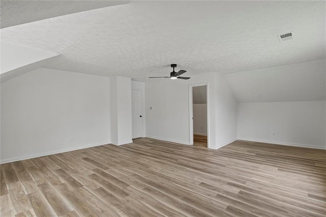1069 Alford Rd, Lithonia, GA 30058 - additional living space featuring a textured ceiling, a ceiling fan, light wood-style flooring, and vaulted ceiling